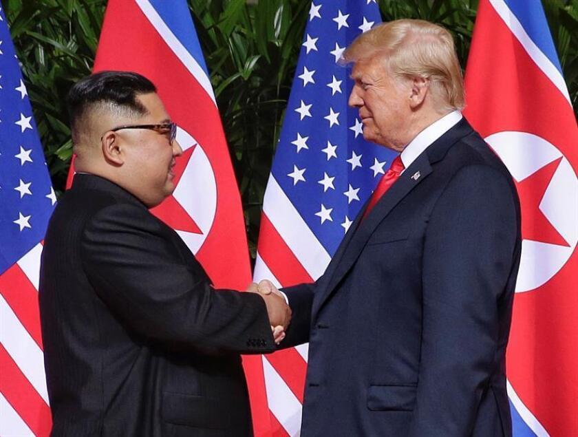 US President Donald J. Trump (R) and North Korean leader Kim Jong-un (L) shake hands at the start of a historic summit at the Capella Hotel on Sentosa Island, Singapore, 12 June 2018 (reissued 19 January 2019). EFE/EPA/KEVIN LIM / THE STRAITS TIMES / SPH SINGAPORE OUT EDITORIAL USE ONLY