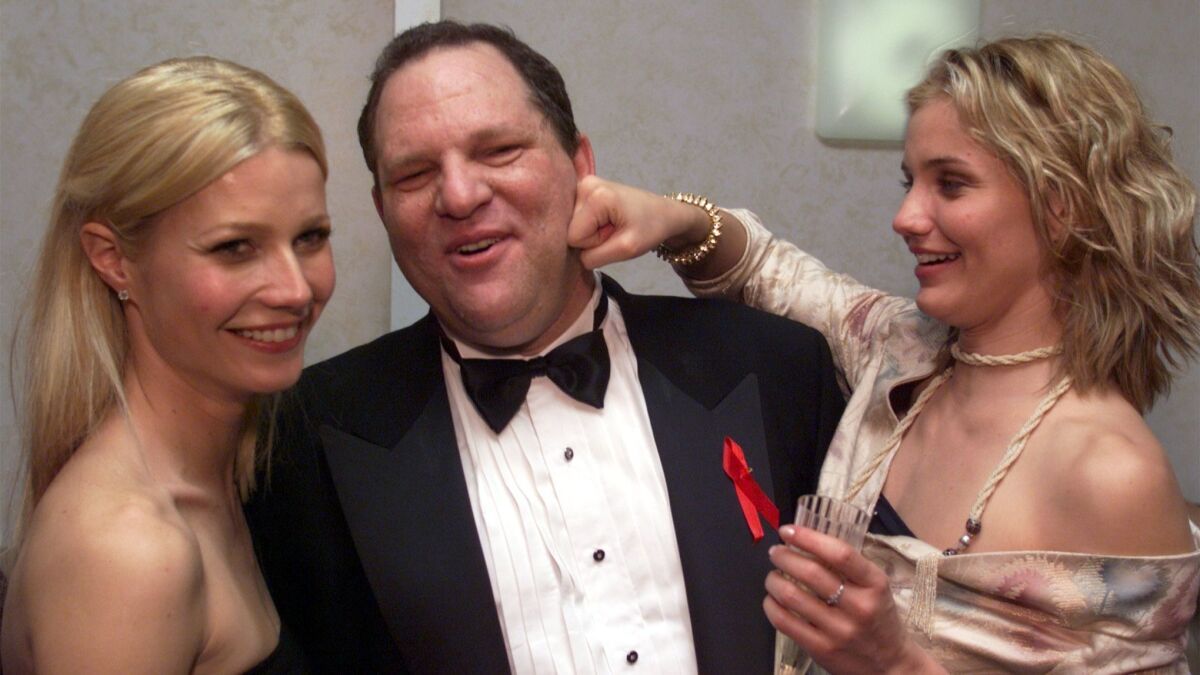 Harvey Weinstein poses with Gwyneth Paltrow, left, and Cameron Diaz during a Golden Globes afterparty at the Beverly Hilton in 1999.