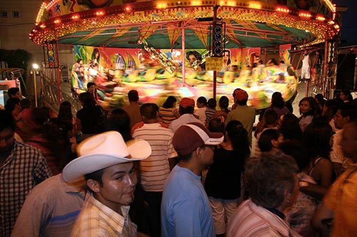 People line up for a turn on the Himalaya carnival ride at the newly enriched summer festival in Mexico's Xalisco County.