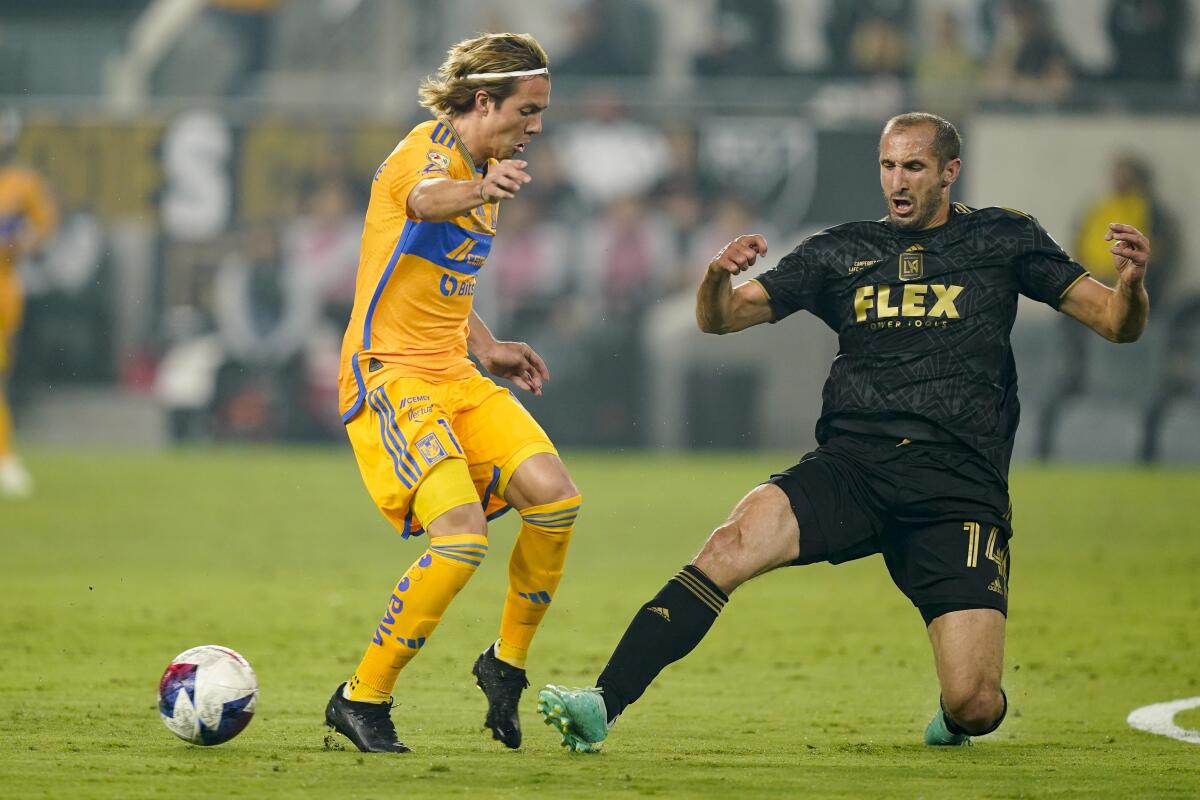 LAFC defender Giorgio Chiellini slide tackles Tigres UANL midfielder Francisco Cordova at BMO Stadium.
