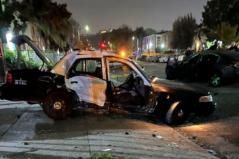 A Los Angeles Police Department patrol unit seen after authorities say the driver of a Nissan sedan crashed into the officers Sunday night.