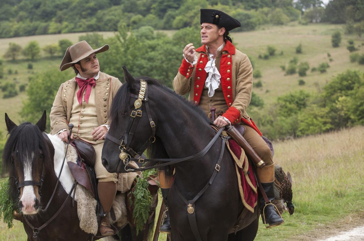 Two men in period costumes on horseback