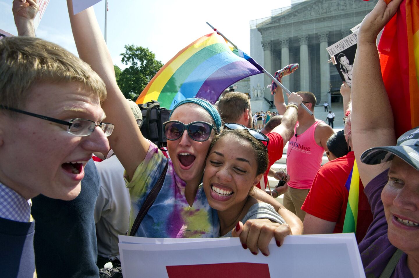 Gay rights activists react outside the U.S. Supreme Court building in Washington after the ruling on California's Proposition 8.