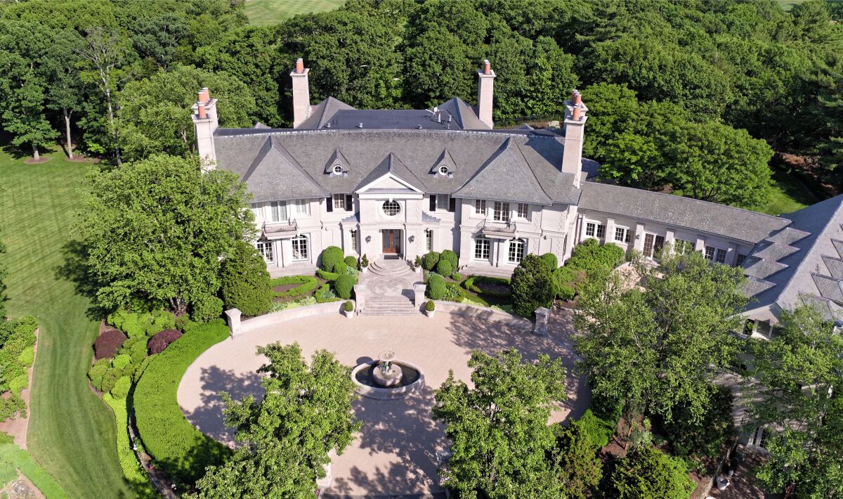 Set on seven acres, the 27,000-square-foot mansion is surrounded by lush landscaping, rolling lawns and meandering paths.