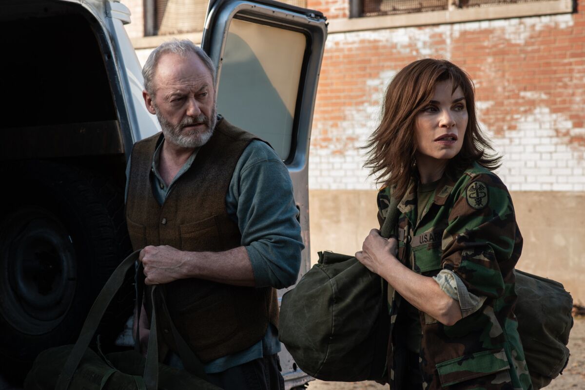 Wade Carter (Liam Cunningham) and Dr. Nancy Jaax (Julianna Margulies) prepare to enter the Reston Monkey Facility in a scene from "The Hot Zone."