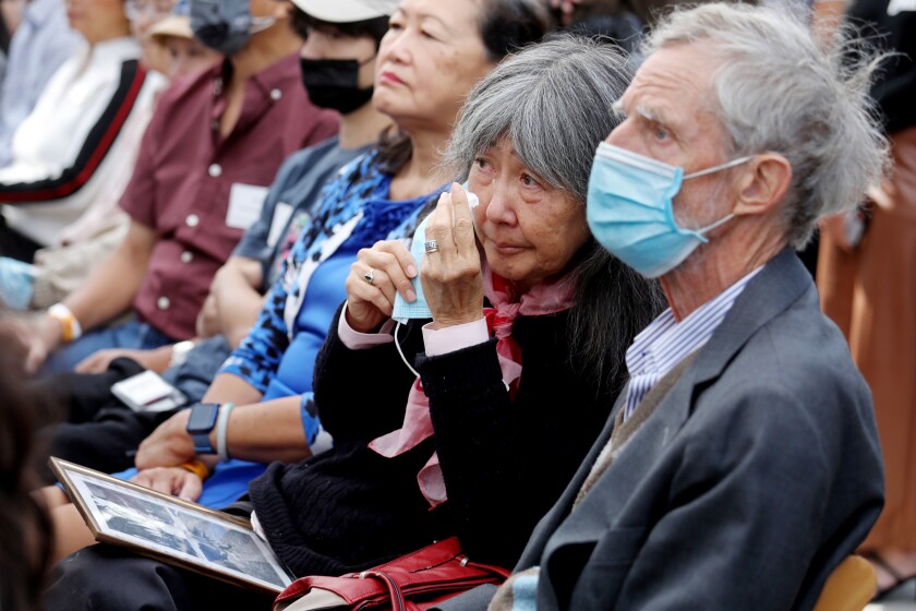 A woman sitting in the audience wipes tears from her eyes