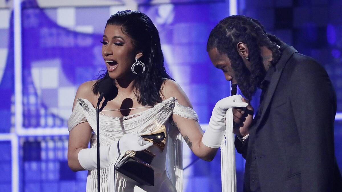 Cardi B accepts the Grammy for rap album — the first solo female artist to win the award.