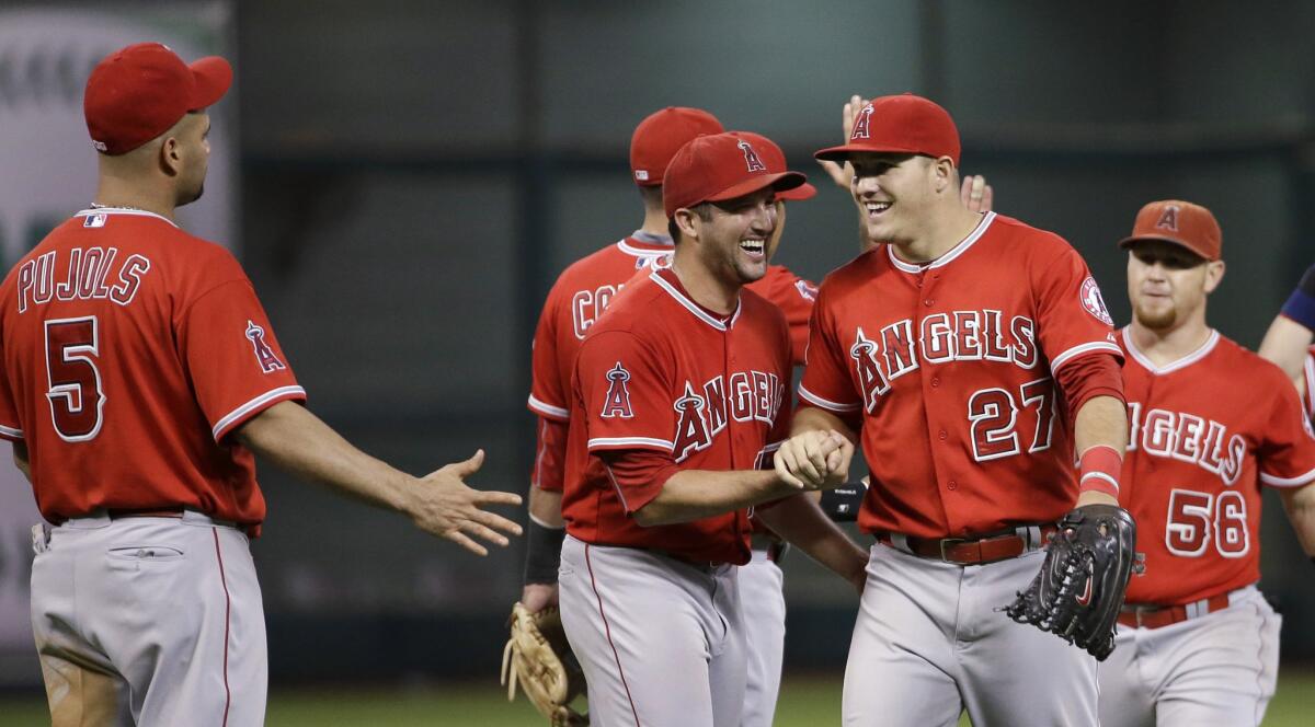 The Angels celebrate a 4-3 win over the Astros at Houston's Minute Maid Park.