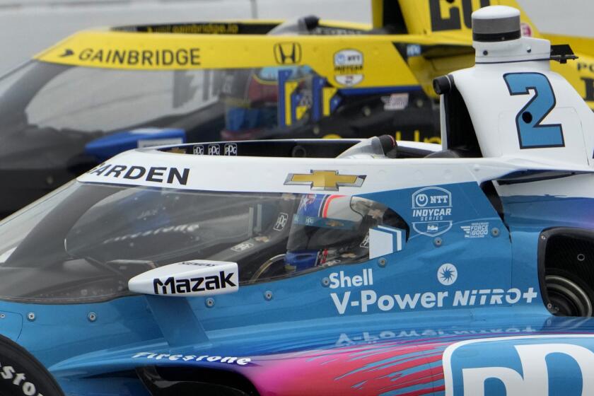 Josef Newgarden (2) drives alongside Colton Herta during an IndyCar auto race at World Wide Technology Raceway, Sunday, Aug. 27, 2023, in Madison, Ill. (AP Photo/Jeff Roberson)