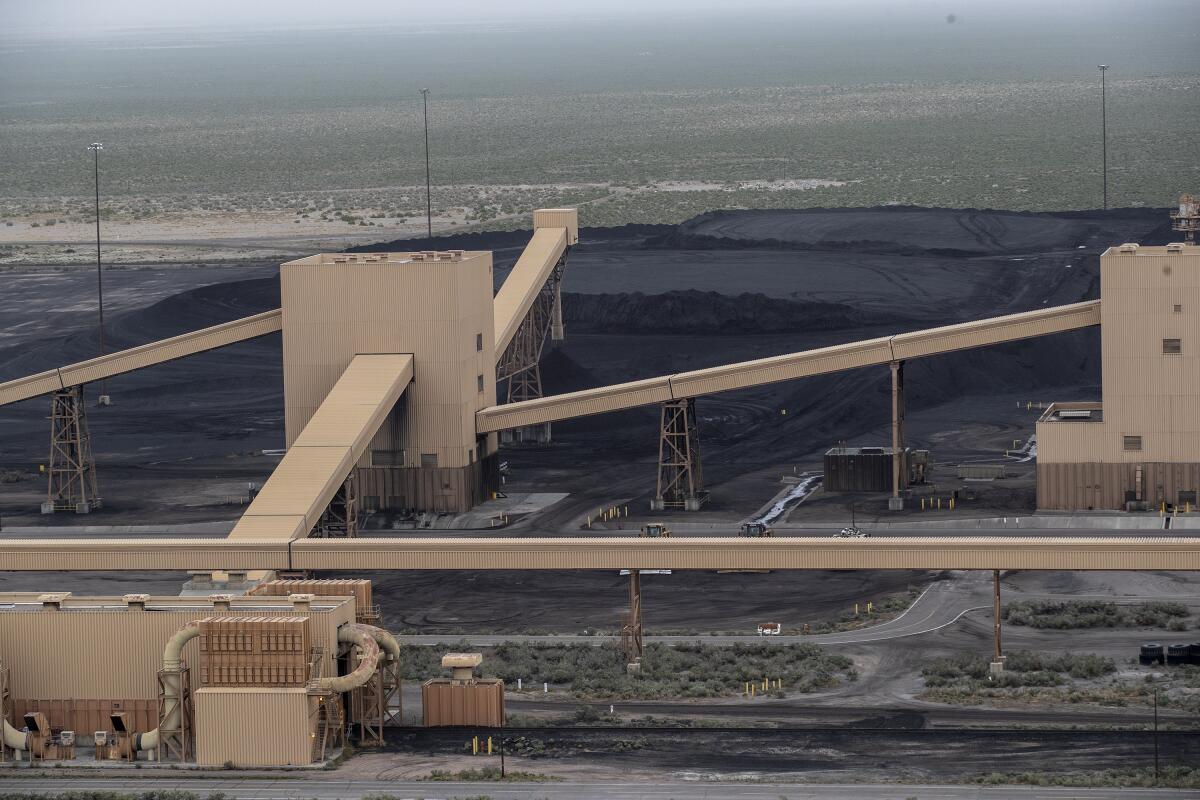 Piles of coal are ready to burn at Intermountain Power Plant outside Delta, Utah, in May 2022.