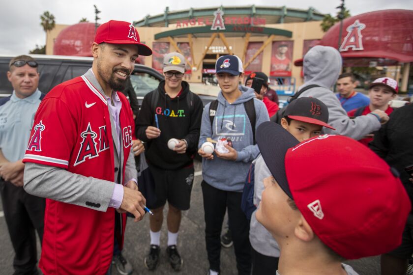 ANAHEIM, CALIF. -- SATURDAY, DECEMBER 14, 2019: Angels All-Star third baseman Anthony Rendon signs autographs and takes photos with fans after an Angels introduced ceremony at Angel Stadium in Anaheim, Calif., on Dec. 14, 2019. (Allen J. Schaben / Los Angeles Times)