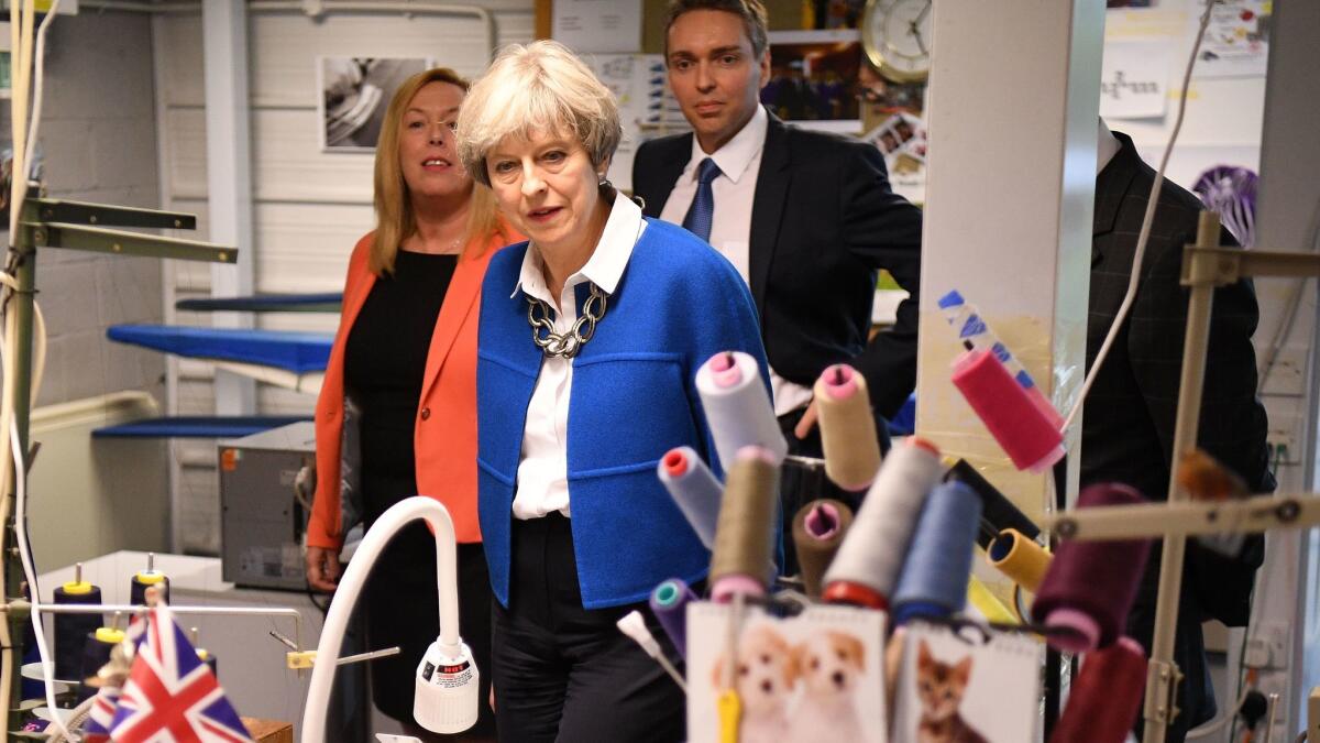 British Prime Minister Theresa May visits Simon Jersey, a business uniform supplier in the Constituency of Hyndburn on May 30, 2017, in Accrington, England. Britain goes to the polls on June 8 to elect a new Parliament in a general election.