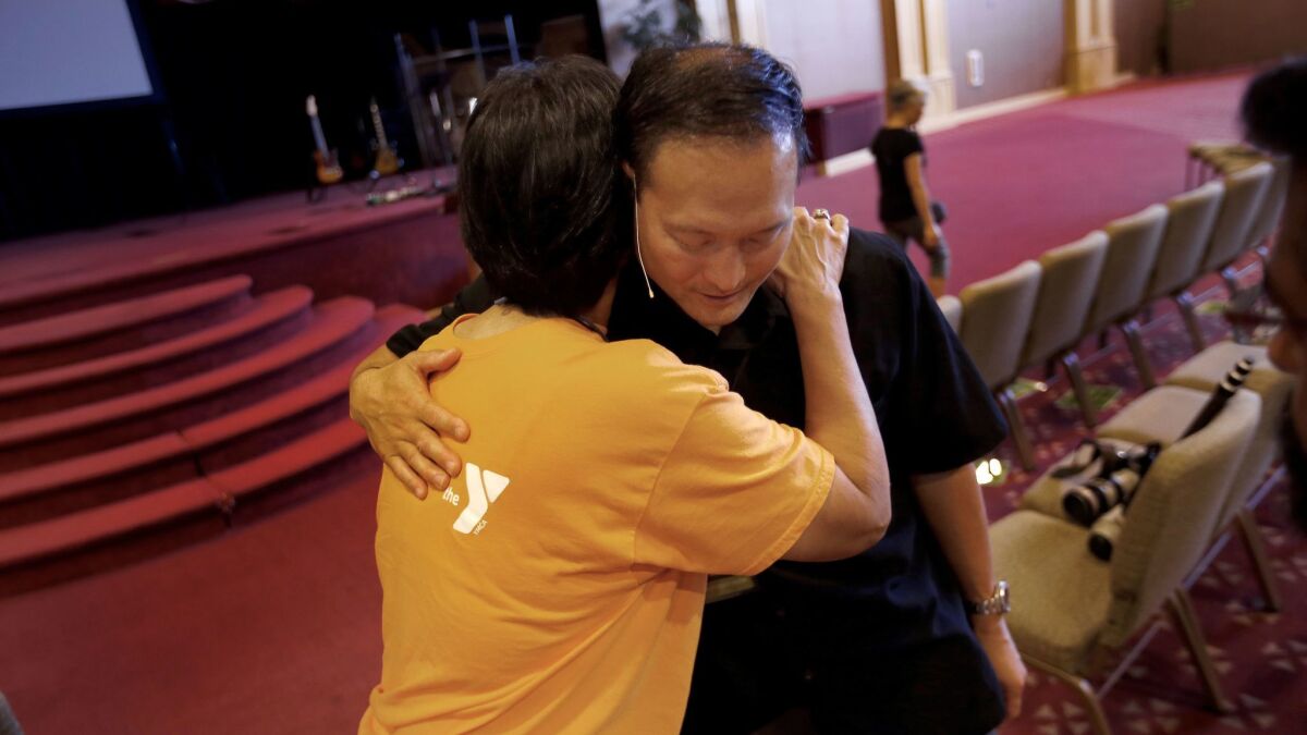 Hilda Tsang hugs Pastor Rocky Seto following Sunday morning service at Evergreen SGV Baptist Church. (Francine Orr / Los Angeles Times)