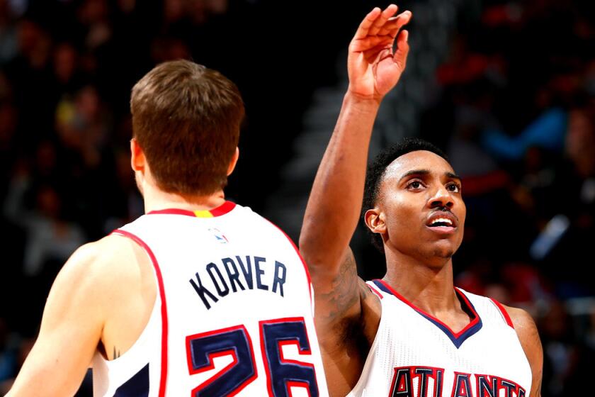 Atlanta's Jeff Teague reacts with teammate Kyle Korver during the Hawks' 96-86 win over the Memphis Grizzlies on Wednesday.