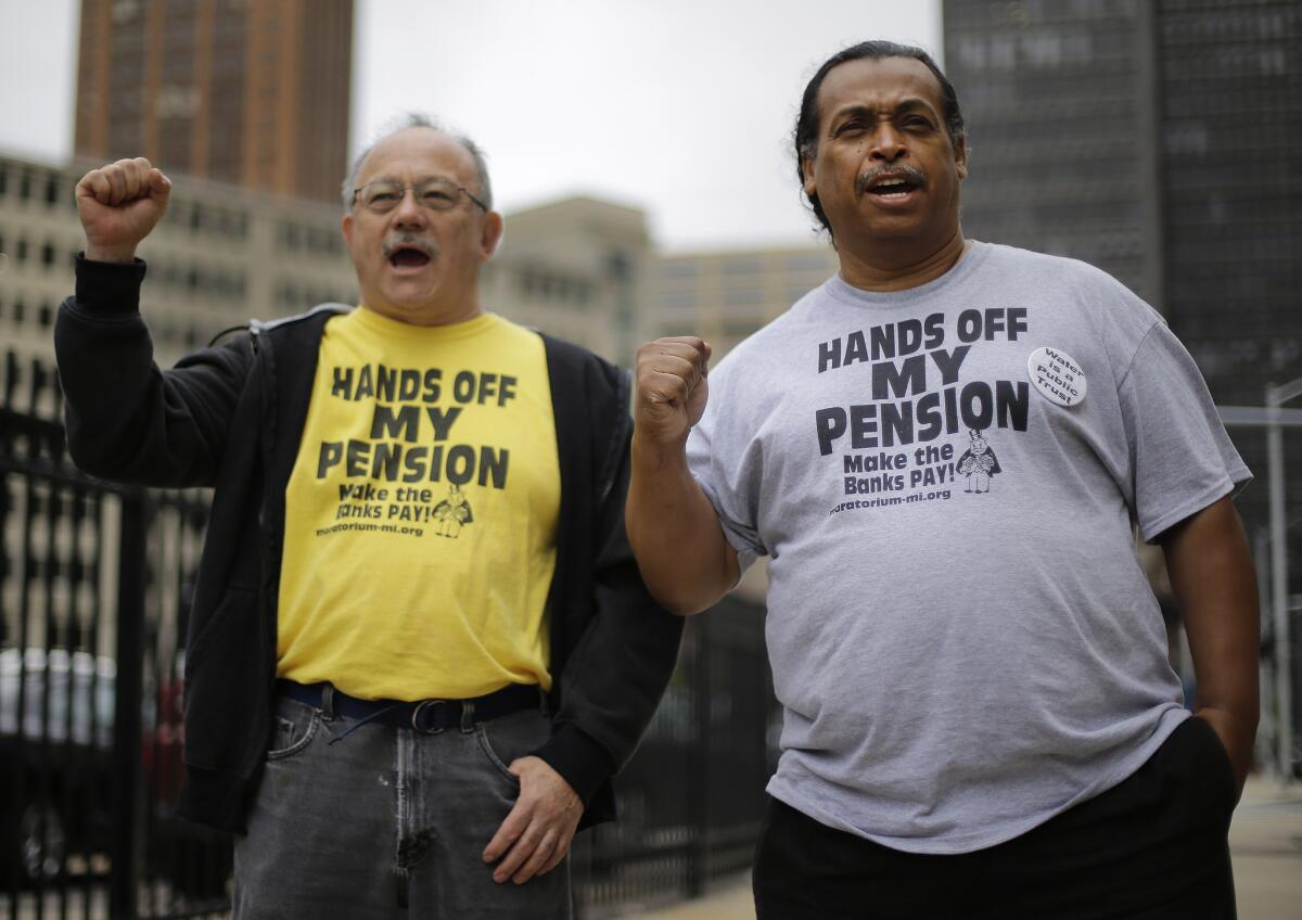 Detroit retirees Mike Shane, left, and William Davis protest near the federal courthouse in Detroit in early July.