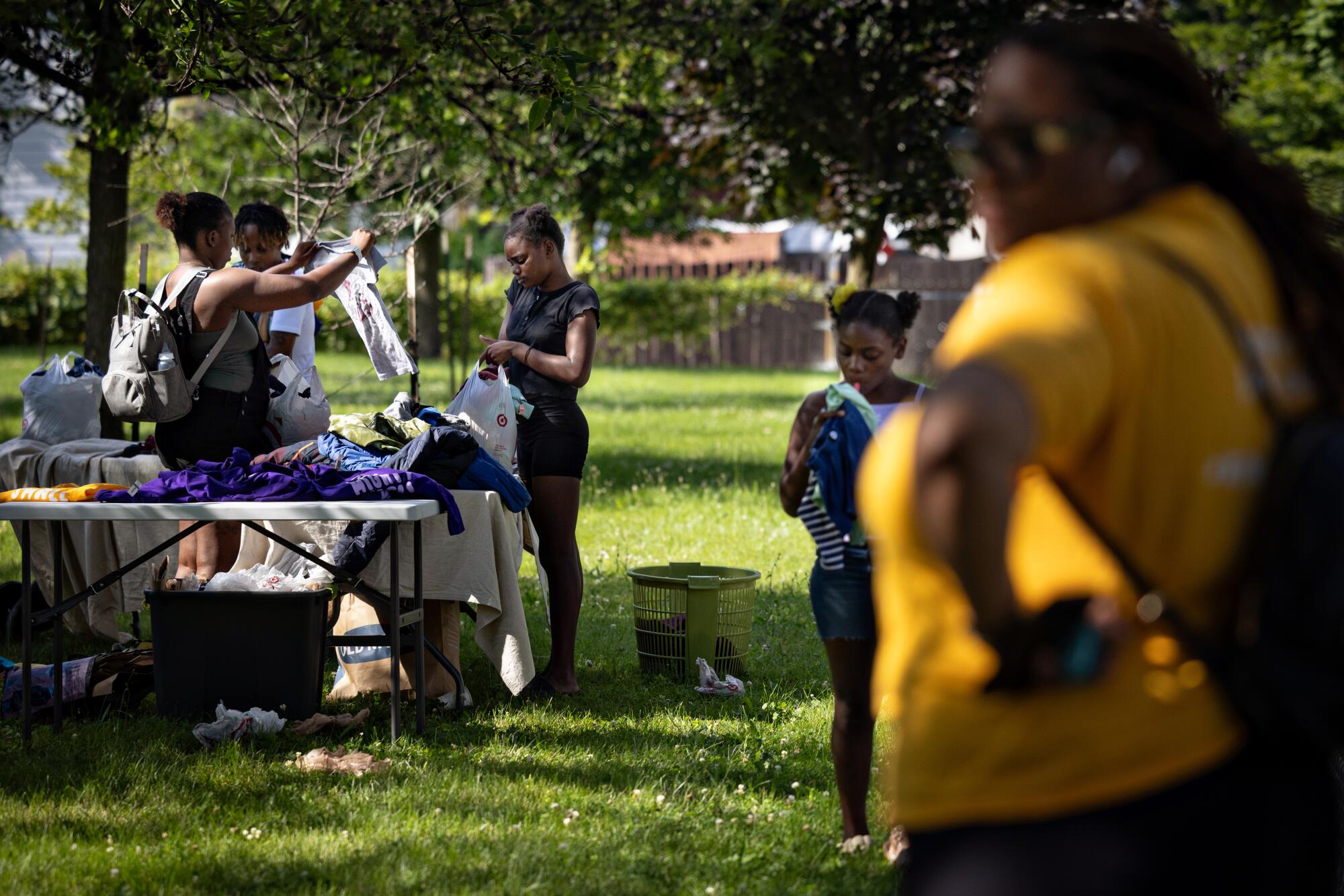 Community members get free clothes at the Milwaukee Childcare Collective event.