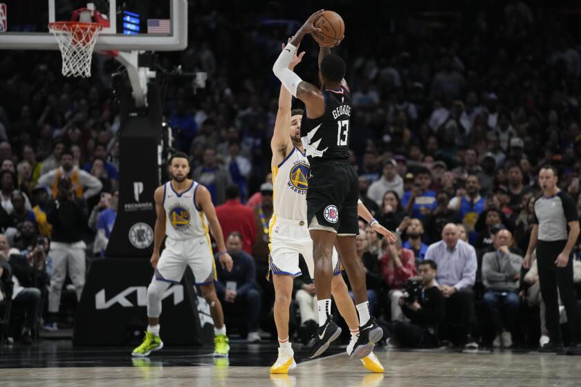 LA Clippers forward Paul George (13) shoots a 3-pointer against Golden State Warriors guard Klay Thompson during the second half of an NBA basketball game in Los Angeles, Saturday, Dec. 2, 2023. The Clippers won 113-112. (AP Photo/Ashley Landis)