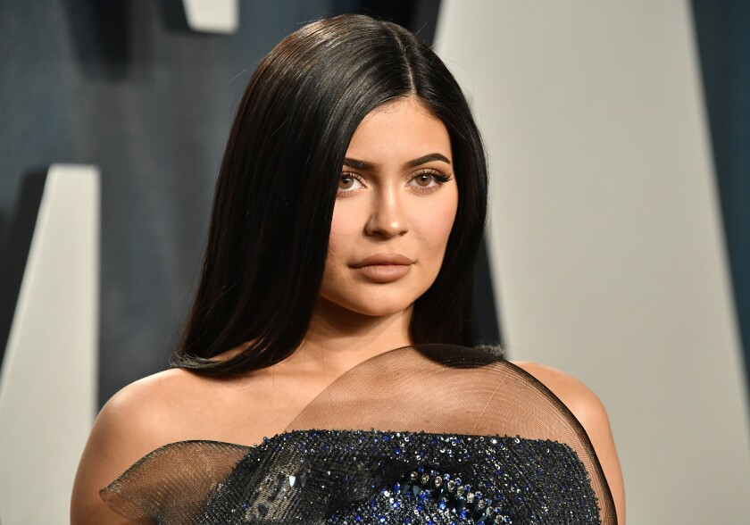 Kylie Jenner shows off her bare shoulders in a sparkly blue dress.