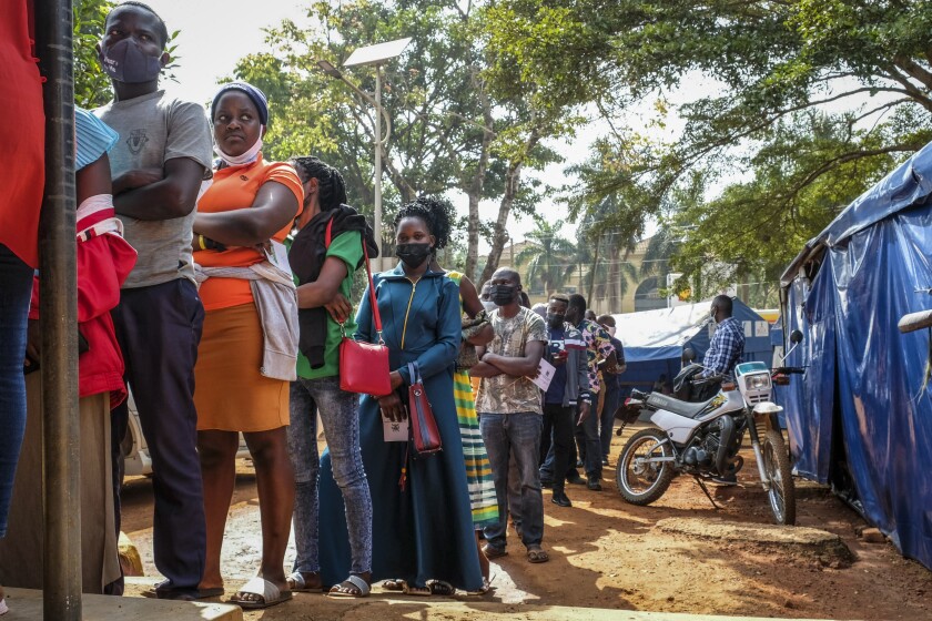 Ugandans queue to receive COVID-19 vaccinations at the Kiswa Health Centre III in Kampala. 