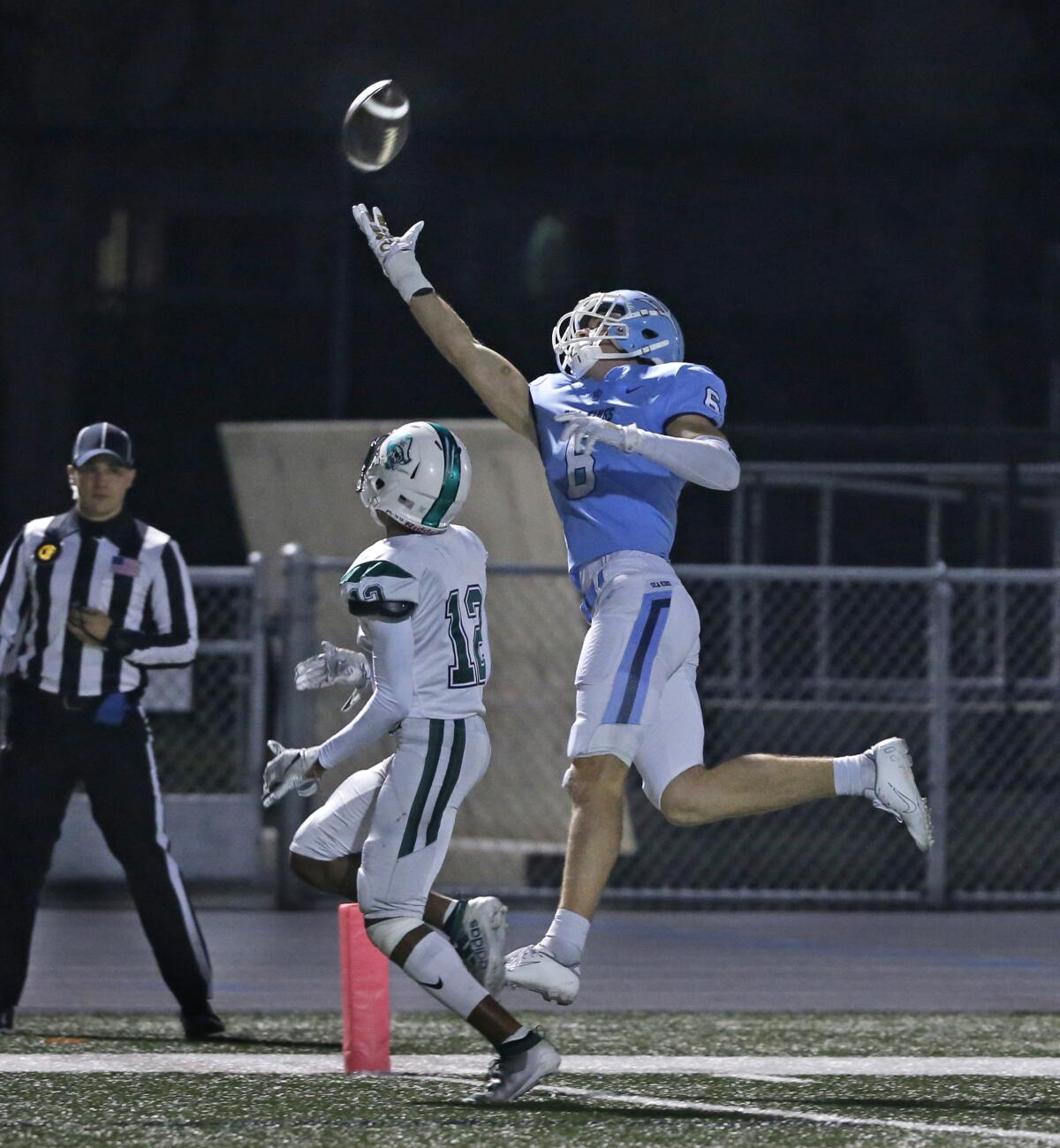 Corona del Mar's John Humphreys (6), pictured stretching out for a pass against Oceanside on Dec. 7, is expected to play in Saturday's CIF State Division 1-A title game. He tweaked his hamstring last week.