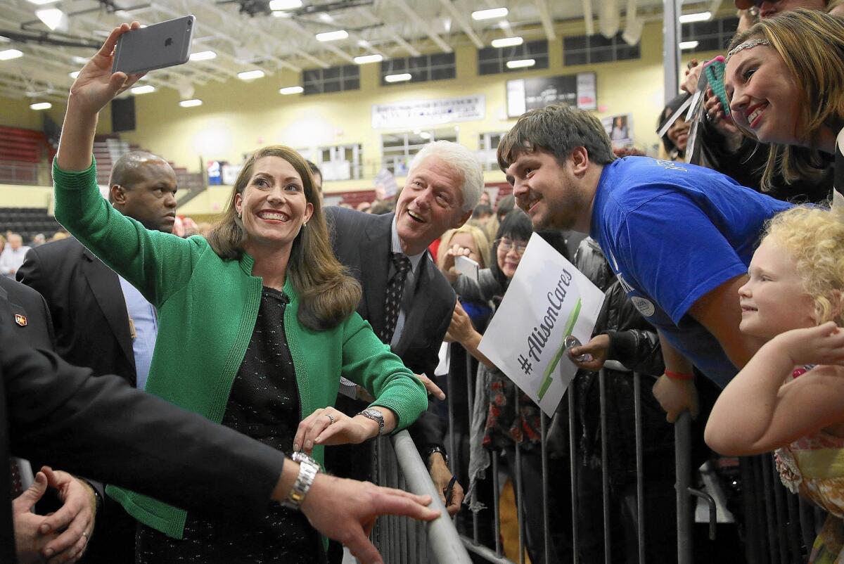 Former President Clinton campaigns in Kentucky with Alison Lundergan Grimes, left, who is running for Senate against Mitch McConnell.