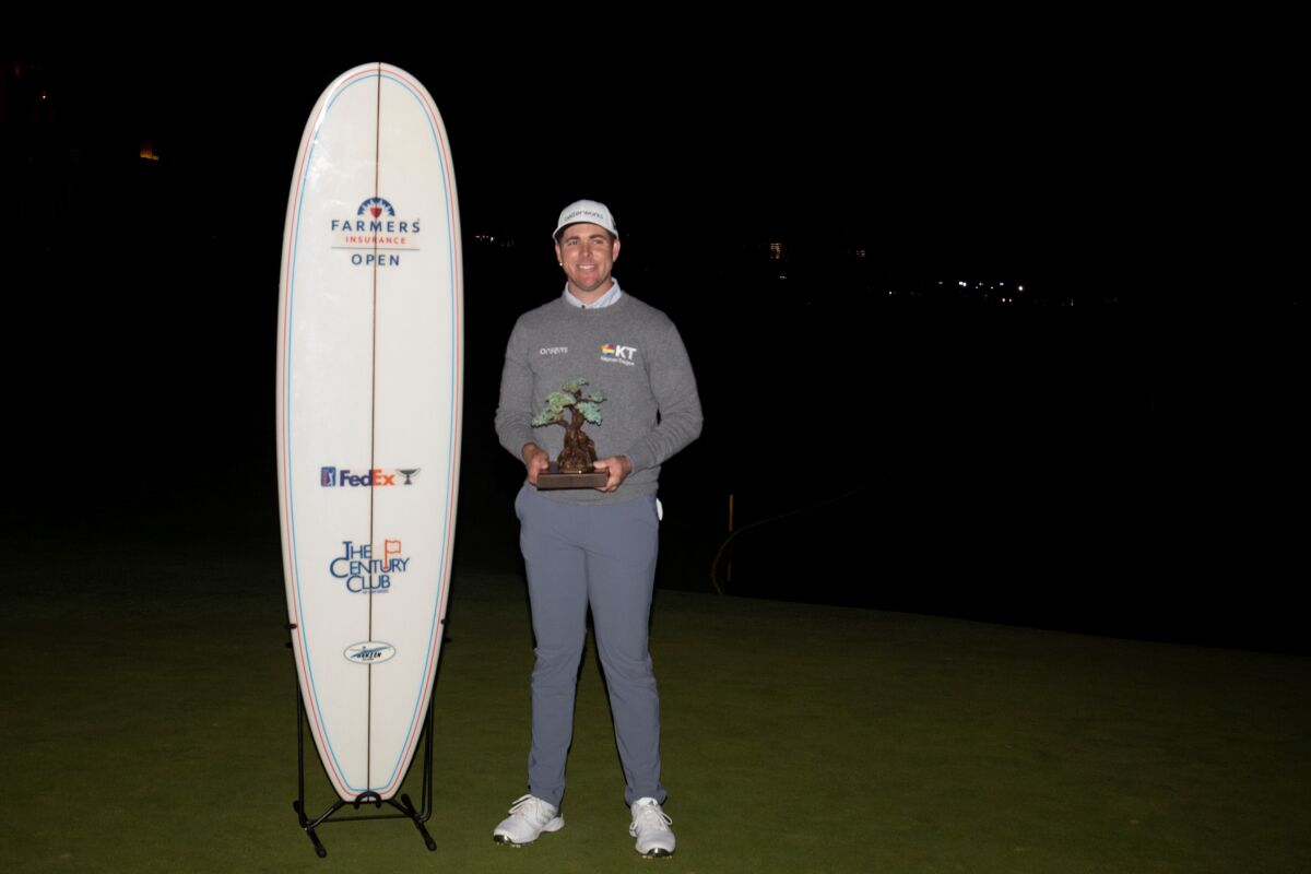 Luke List holds his Farmers Insurance Open championship trophy in 2022.