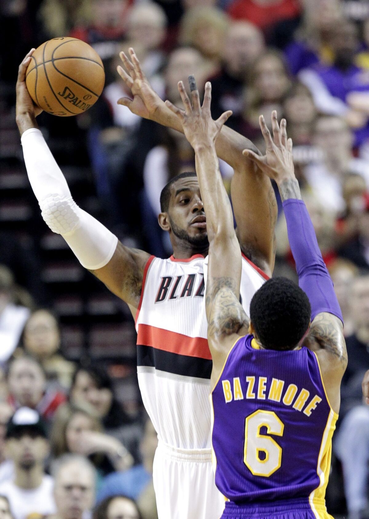 Portland Trail Blazers forward LaMarcus Aldridge looks to pass over Lakers guard Kent Bazemore.