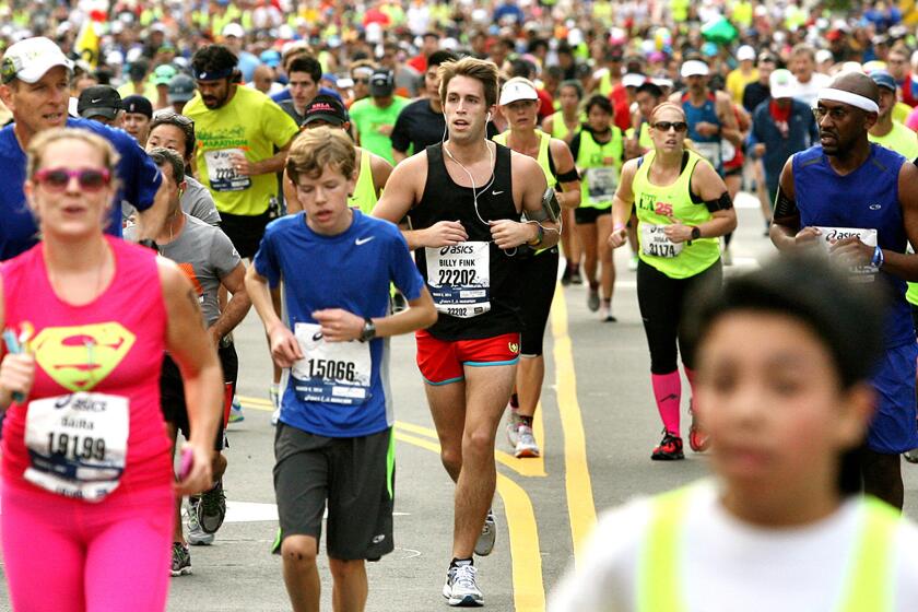 Runners pass through downtown Los Angeles during the 2014 L.A. Marathon.