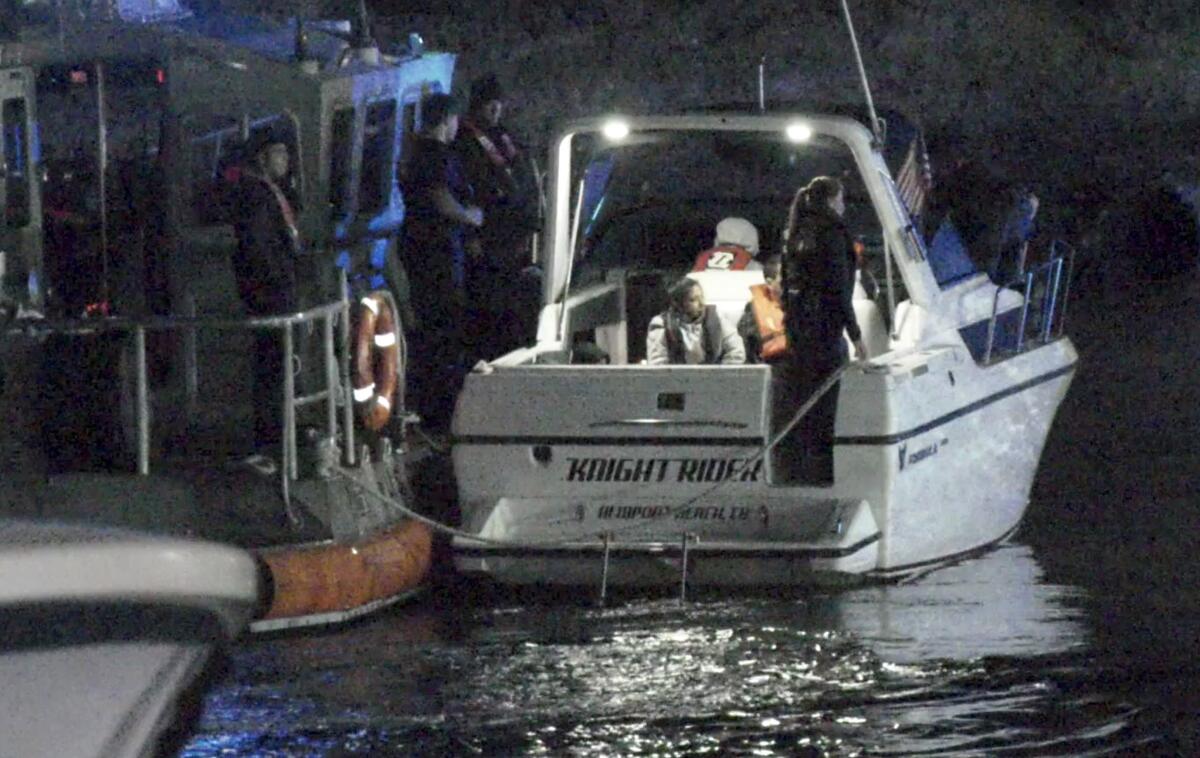 The Coast Guard tows in boat with migrants aboard