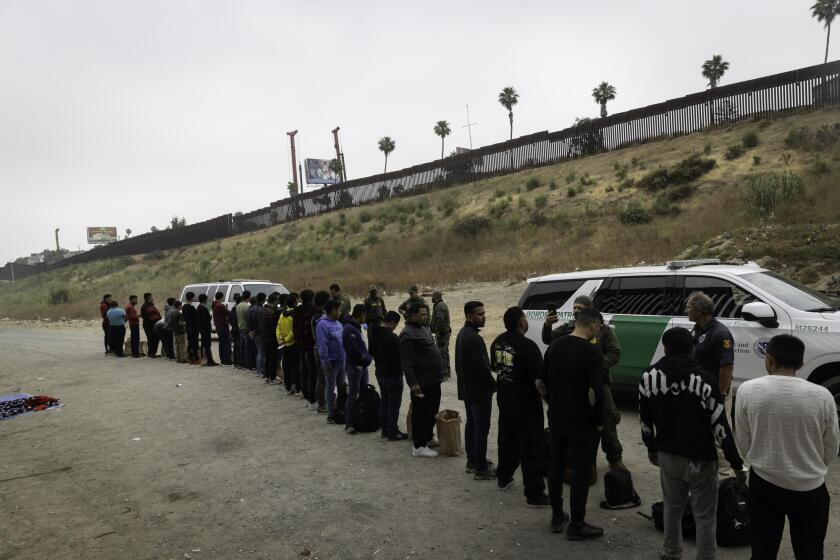 San Diego, California - June 05: About 70 migrants between the U.S.-Mexico border walls wait to be processed by U.S. Border Patrol agents after President Joe Biden's order to restrict asylum on Wednesday, June 5, 2024 in San Diego, California. (Ana Ramirez / The San Diego Union-Tribune)
