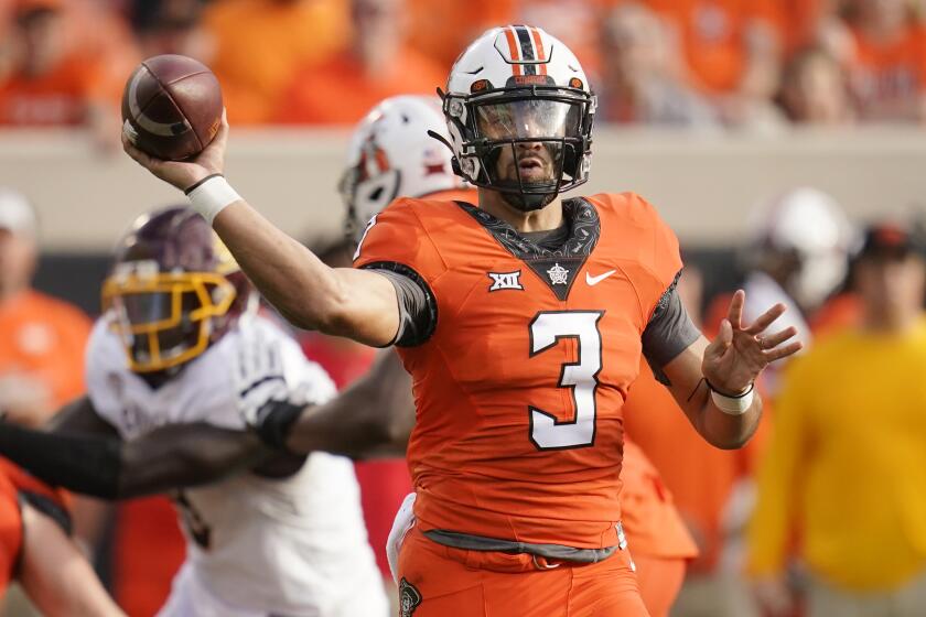 Oklahoma State quarterback Spencer Sanders (3) throws a pass during the first half.
