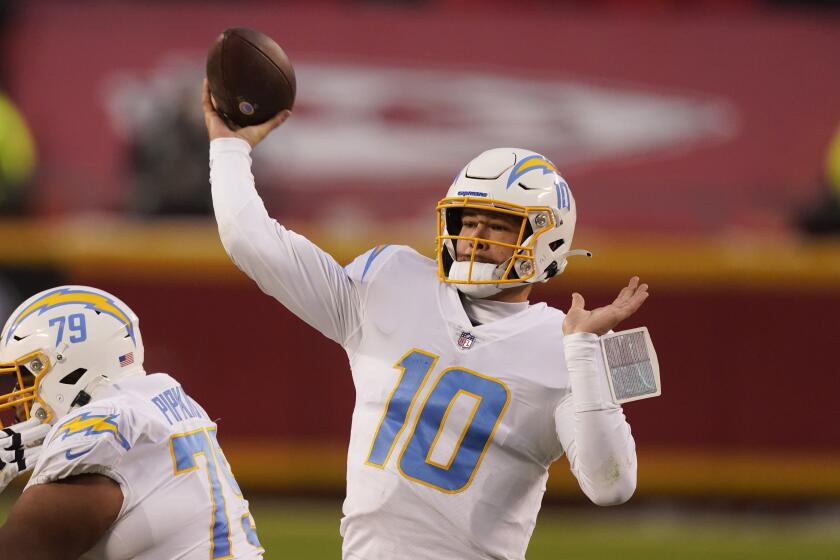 Los Angeles Chargers quarterback Justin Herbert throws a pass during the first half.