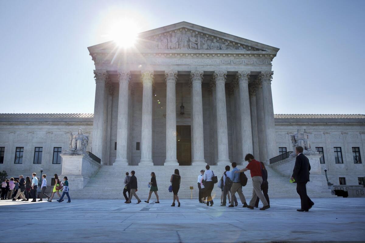 A line of people enter the Supreme Court in Washington on June 29, 2015. The court met for the final time on Monday until the fall to consider state efforts to reduce partisan influence in congressional redistricting, among other issues.