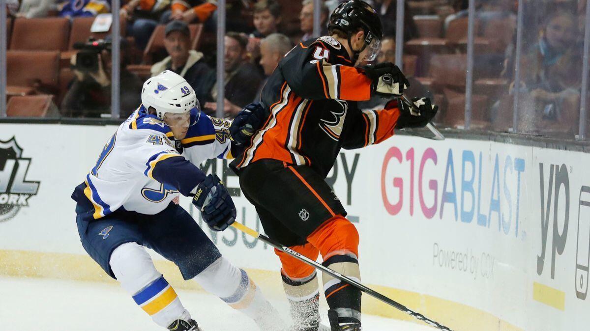 St. Louis Blues' Ivan Barbashev, left, reaches for the puck against Ducks' Cam Fowler during the first period Wednesday.