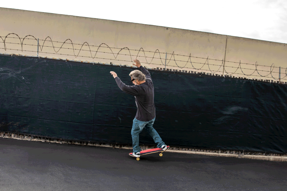 Jim Gray is photographed skating in a parking lot.