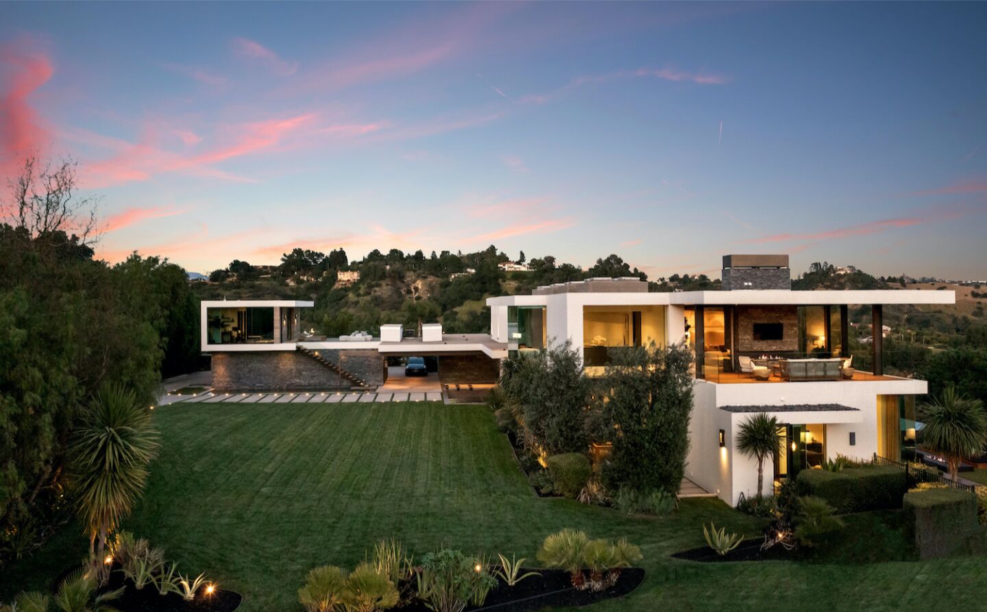The 11,000-square-foot showplace sits on a three-acre promontory and ascends to a rooftop deck overlooking the canyons.
