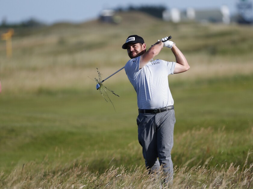 Louis Oosthuizen plays out of the rough on the 13th hole during the third round of the British Open.