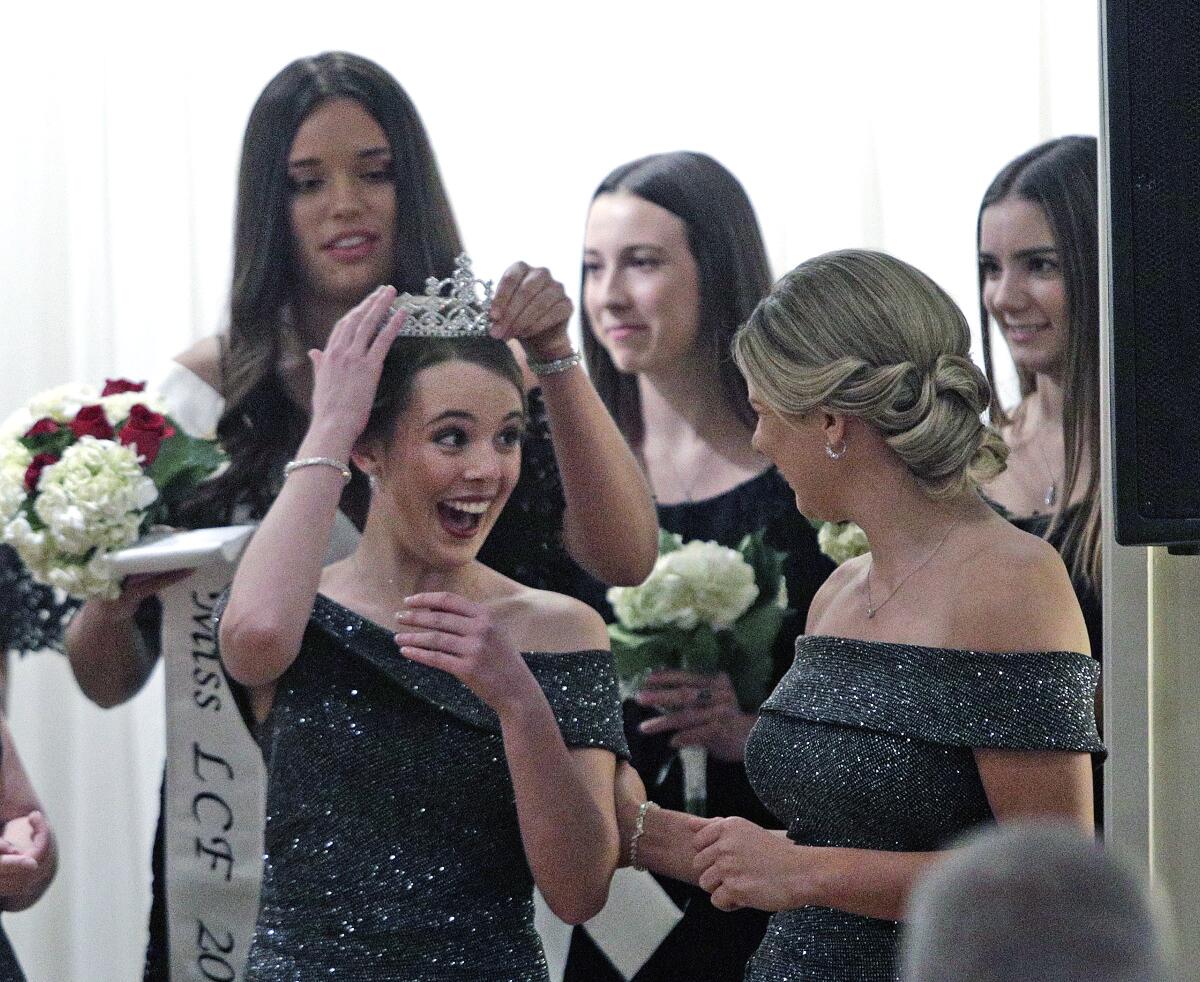 Miss La Cañada Flintridge of 2020, Ally Rayer, looks to court member Reese Ramseyer as she's given a crown by outgoing Miss LCF Francesca Christensen at the 108th Installation and Awards Gala at the La Cañada Flintridge Country Club on Thursday, Jan. 30.