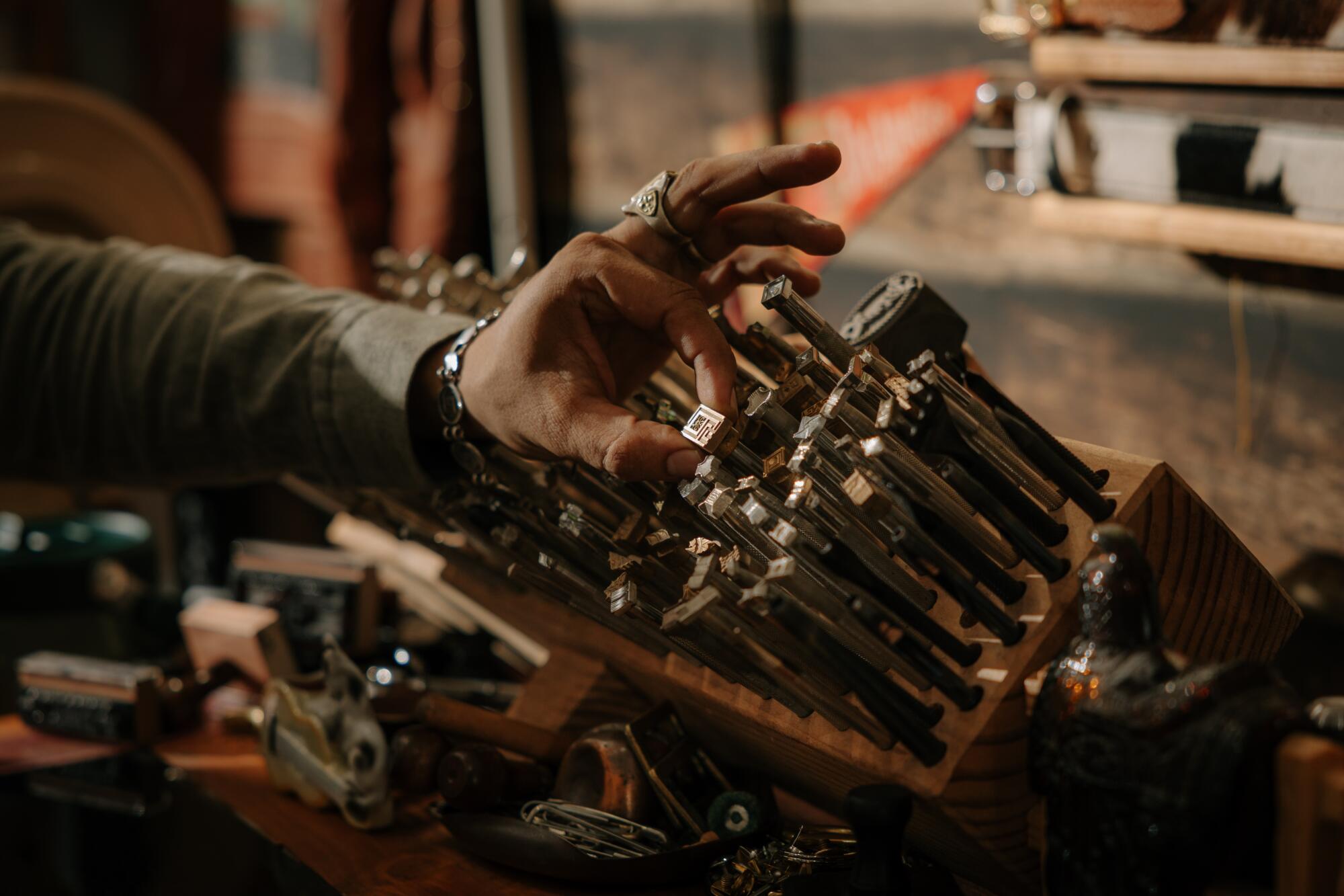 Los Angeles, CA - July 28: Guillermo Cuevas selects a leather stamp at Dunrite Leatherworks 