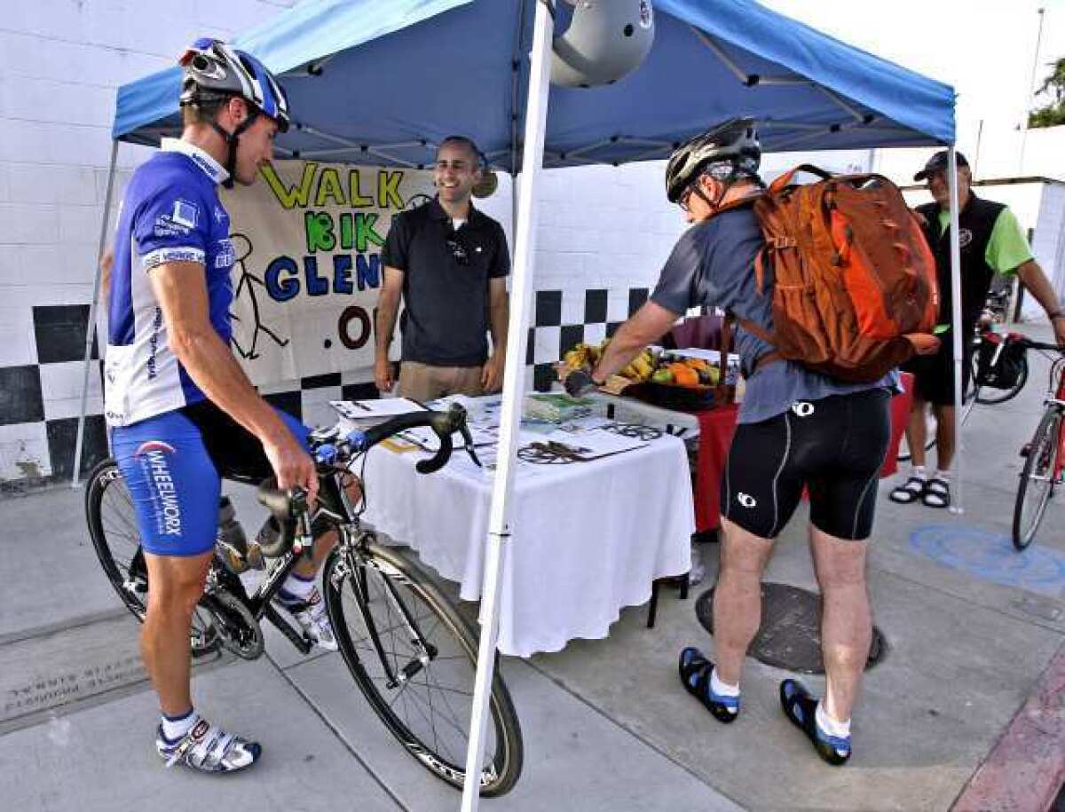 Cyclist David McNeal, left, talks with Bike Walk Glendale volunteer Erik Yesayan, center, and Jim McKenzie, right, at the Sonora Avenue and Flower Street Bike To Work Day pit stop in Glendale. McNeal was heading to work in Glendale from Highland Park and McKenzie was traveling from La Canada Flintridge to Burbank for work.