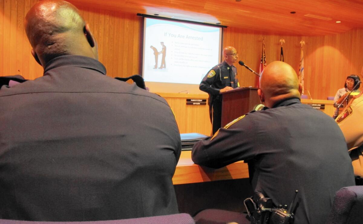 Police officers in Rocky Mount, N.C., listen to a presentation by Capt. Martin McCoy at a "Know Your Rights" night this week. The event was designed to let residents question police about their tactics and thinking when they stop young black men.