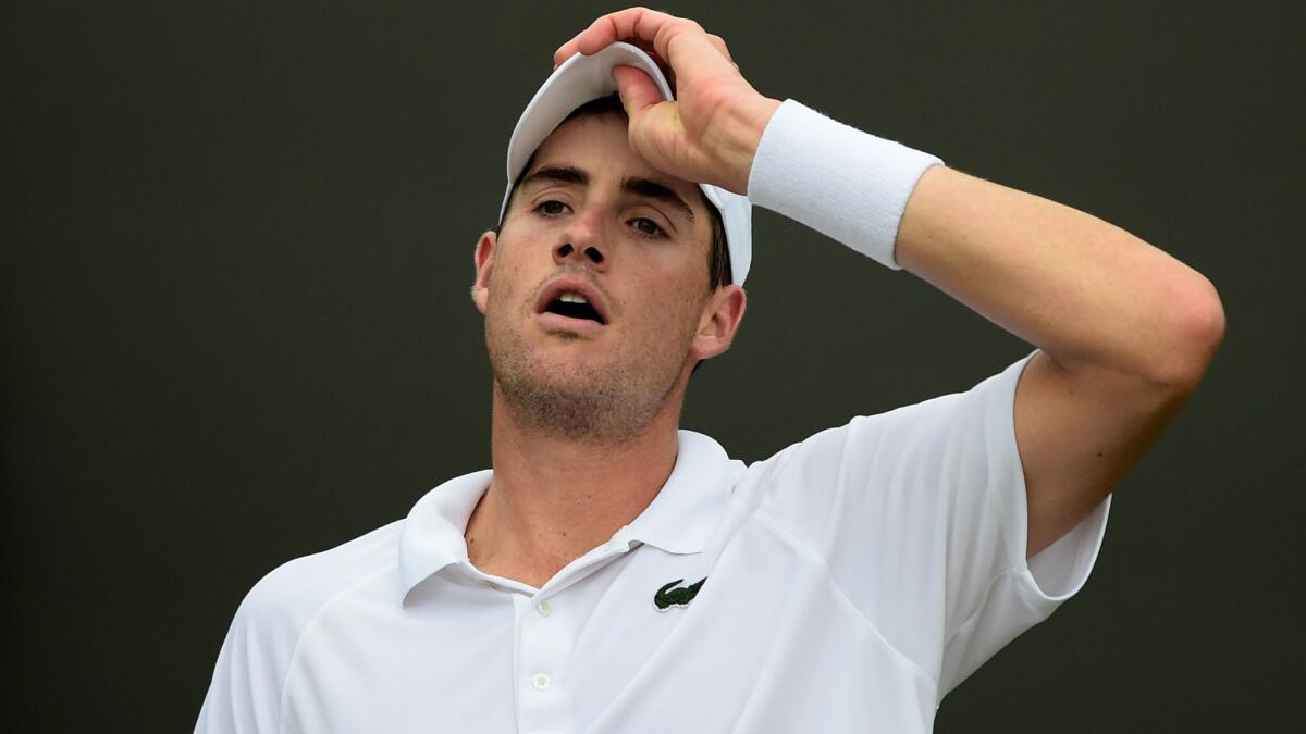 American John Isner catches his breath during his second-round win over Jarkko Nieminen at Wimbledon on Thursday. The American presence in the Wimbledon tournament this year has been underwhelming.