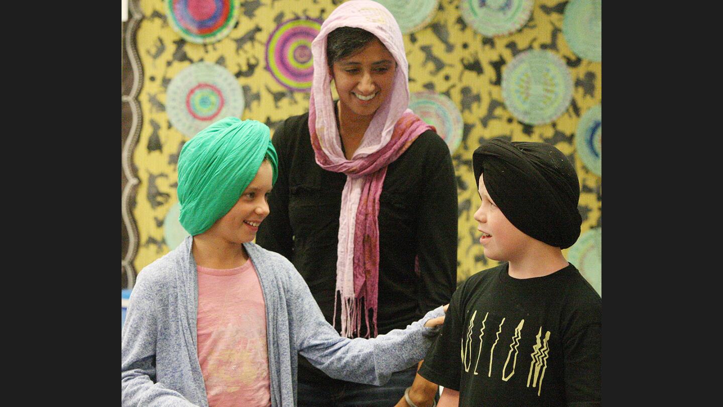 Bhupinder Kaur Malik smiles as Caitlin Aguilar, 8, and Jake Livarez, 9, take a good look at each other during the first time they have ever had a turban on their head at Paradise Canyon Elementary.