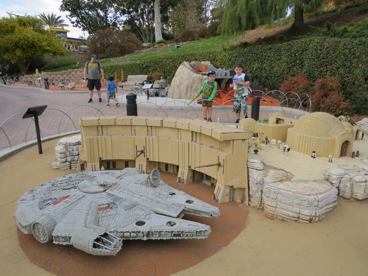 Boys admire the Tatooine display, including the Millennium Falcon ship in the foreground, at Legoland California theme park in Carlsbad on Nov. 18. The Star Wars Miniland attraction will close Jan. 6, 2020.