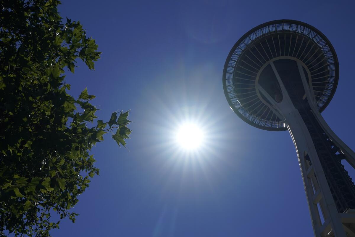 The sun shines on the Space Needle in Seattle
