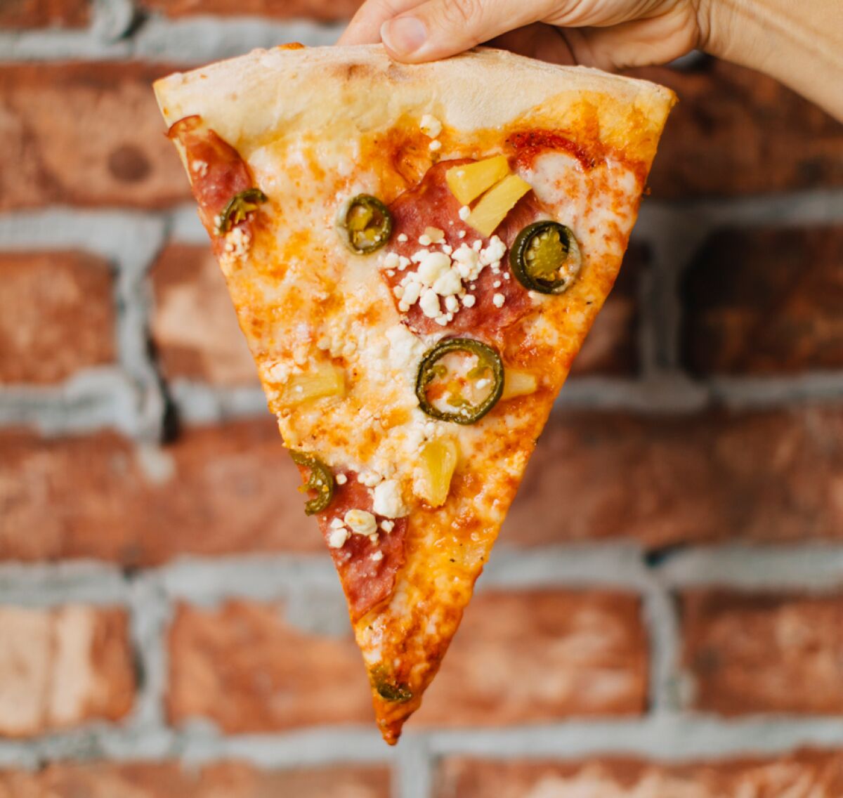 A slice of pizza from Mr. Moto pizzeria chain.