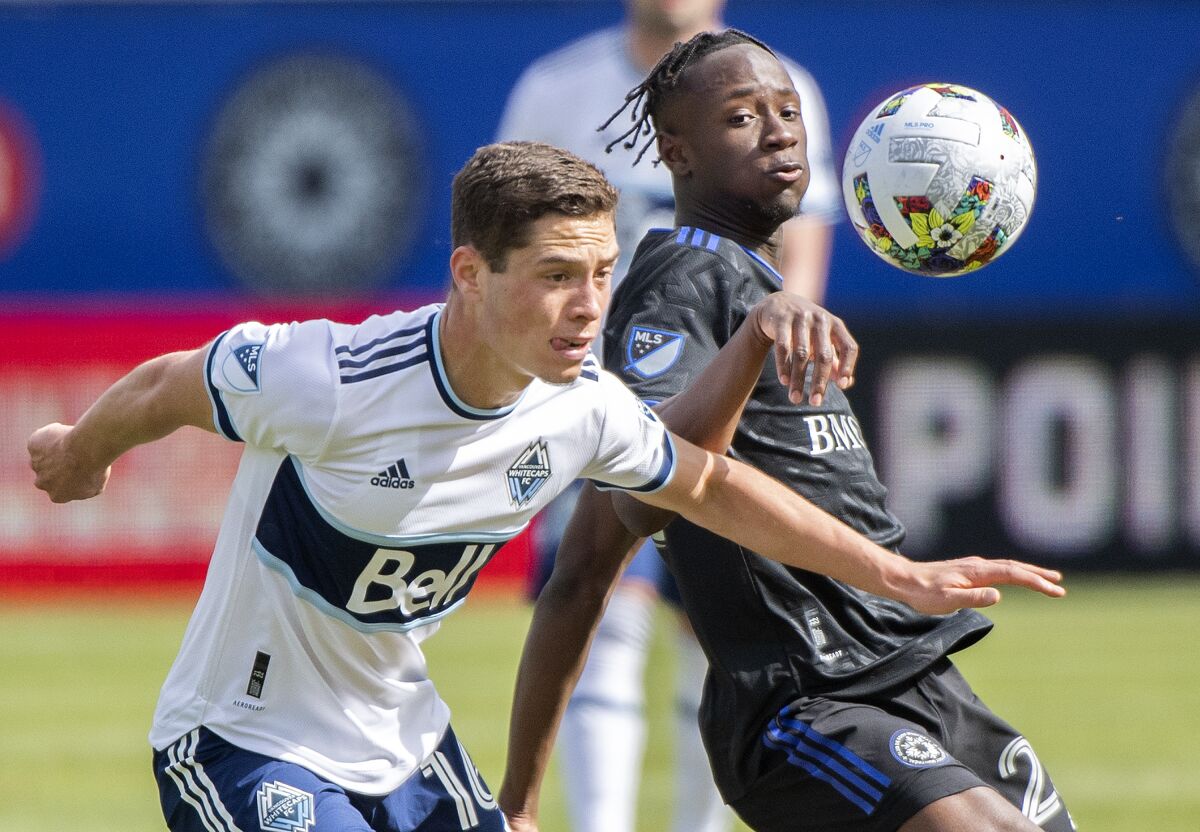 CF Montreal's Ismael Koner, right, challenges Vancouver Whitecaps' Sebastian Berhalter during first-half MLS soccer match action in Montreal, Saturday, April 16, 2022. (Graham Hughes/The Canadian Press via AP)