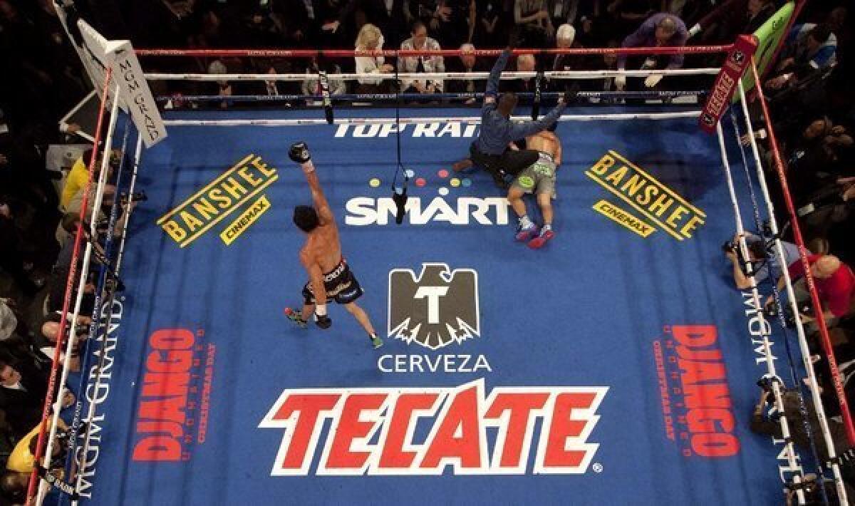 Juan Manuel Marquez, left, begins to celebrate as referee Kenny Bayless calls Manny Pacquiao down for the count in the sixth round.