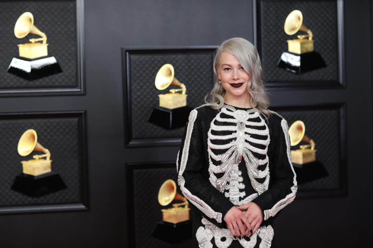 A woman with platinum-blond hair wears a glam skeleton suit at an event