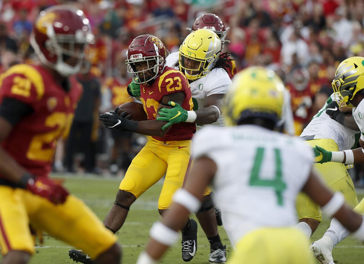 USC running back Kenan Christon looks for room to run against Oregon in the second quarter at the Coliseum on Saturday.